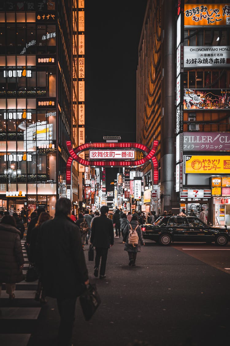 People Walking Down Street Of Kabukicho At Night