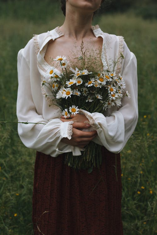 Woman Holding Bunch of Flowers from Field