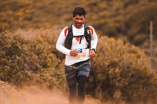 Free A determined man running through a scenic nature trail, embracing outdoor fitness and adventure. Stock Photo