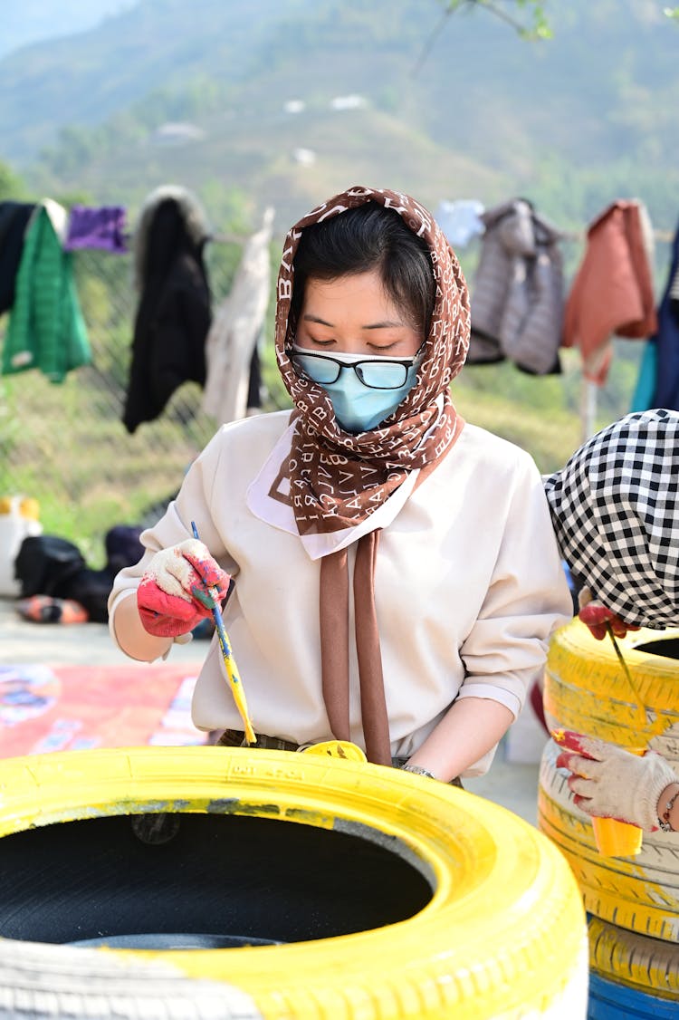 Woman Painting Tire