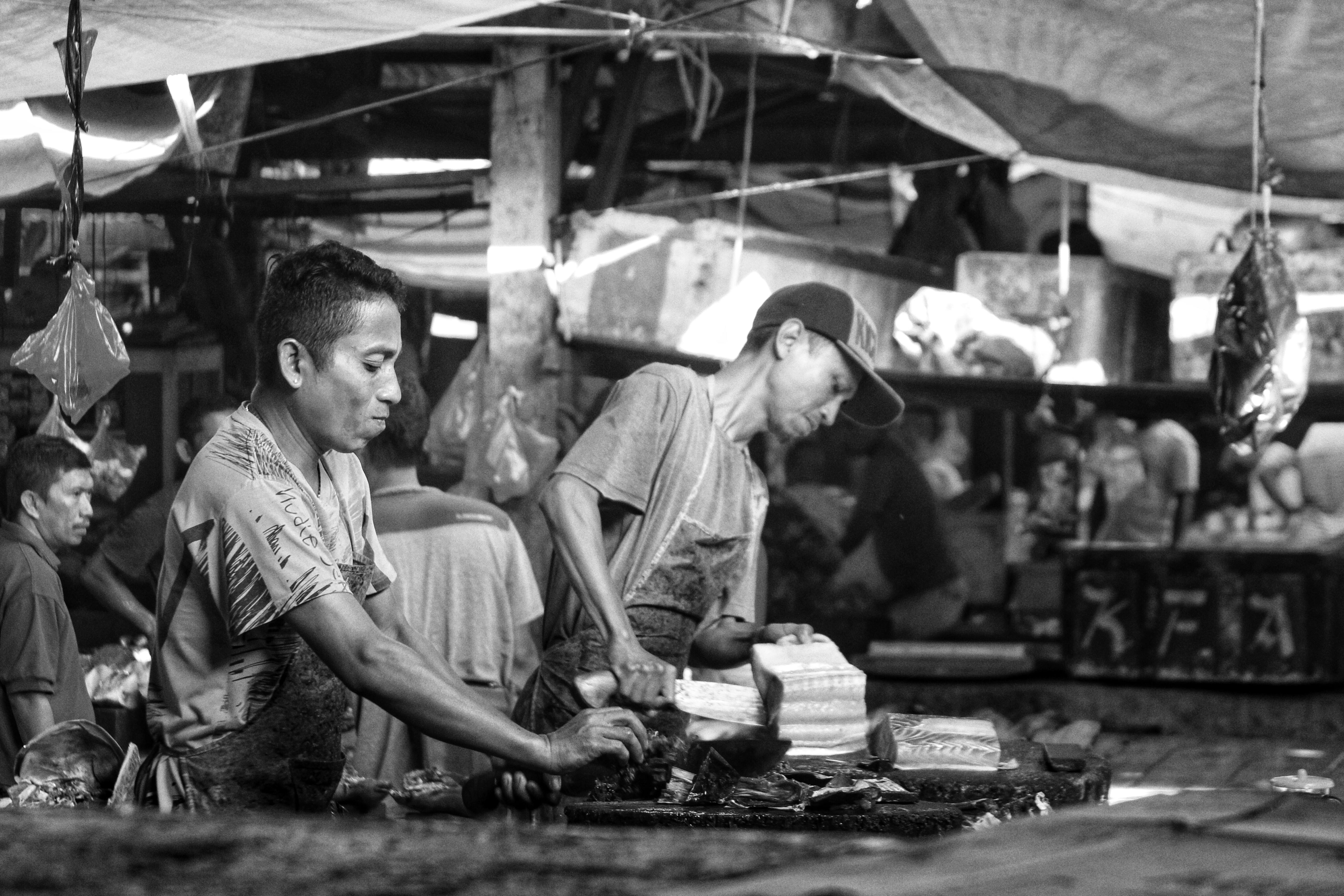 a man slicing fish in the marker