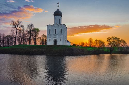 Free Historic white church on riverside in Bogolyubovo, Russia during sunset. Stock Photo