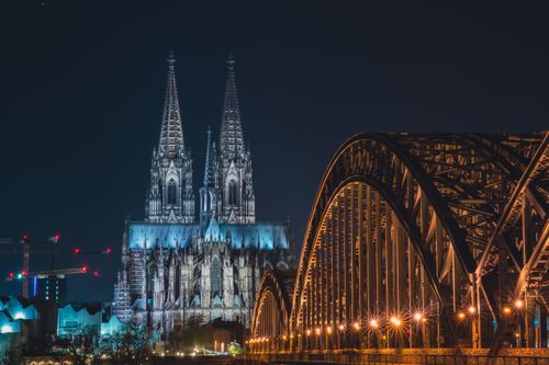 Free Stunning night view of Cologne Cathedral and Hohenzollern Bridge in Germany. Stock Photo