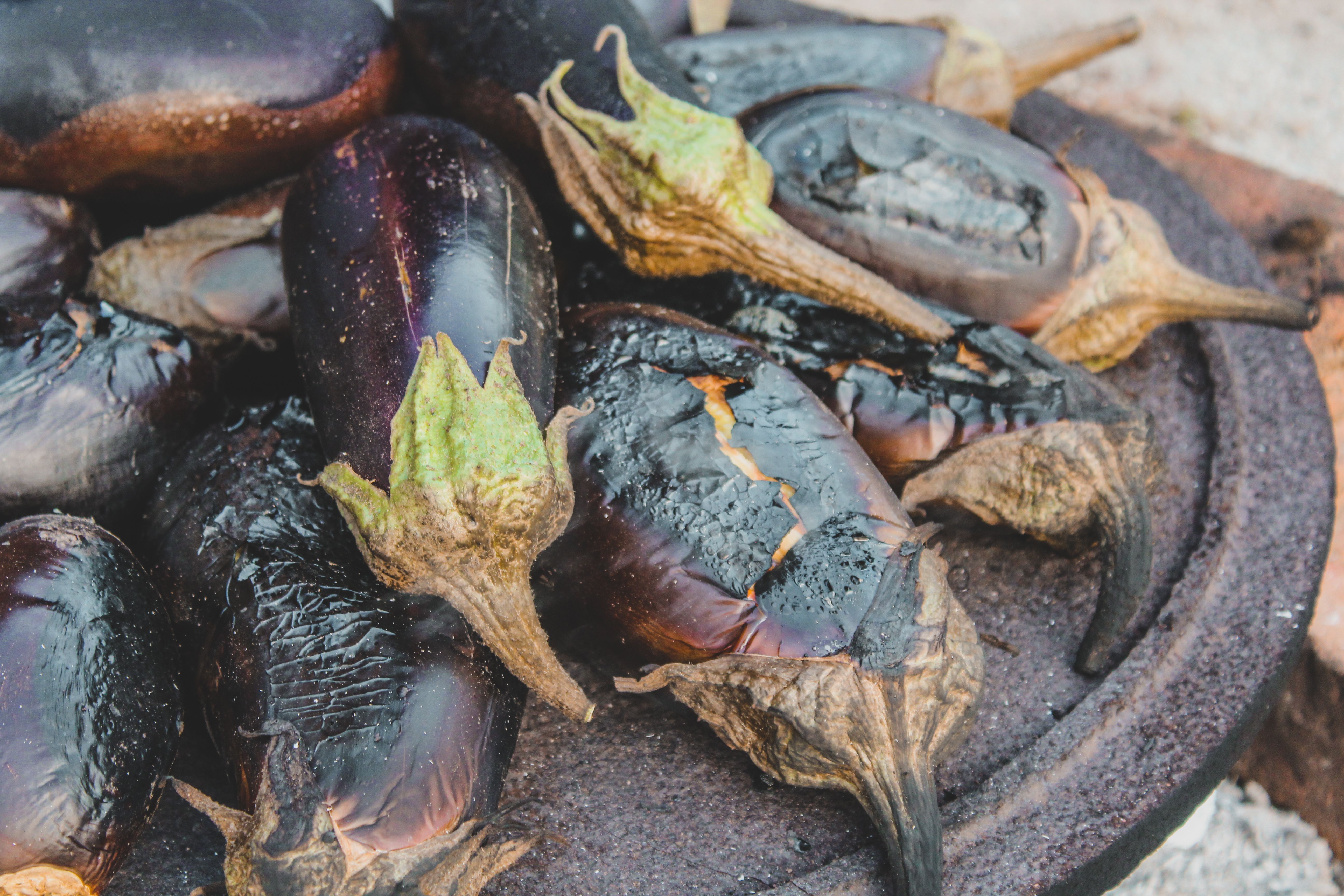 Fresh purple eggplants on a wooden table