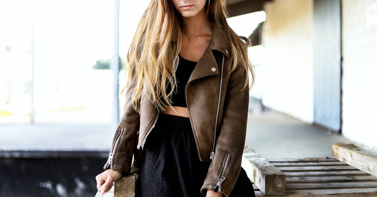 A fashion-forward woman poses confidently in Silkeborg wearing a leather jacket.