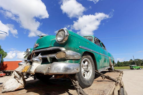 Free Green Classic Car on a Truck Stock Photo