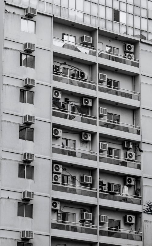 Free Black-and-white photo of an apartment building with balconies in Dubai. Stock Photo