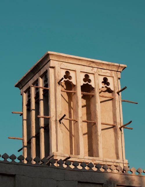 Free Low angle shot of a traditional wind tower in Dubai, showcasing intricate design against a clear blue sky. Stock Photo