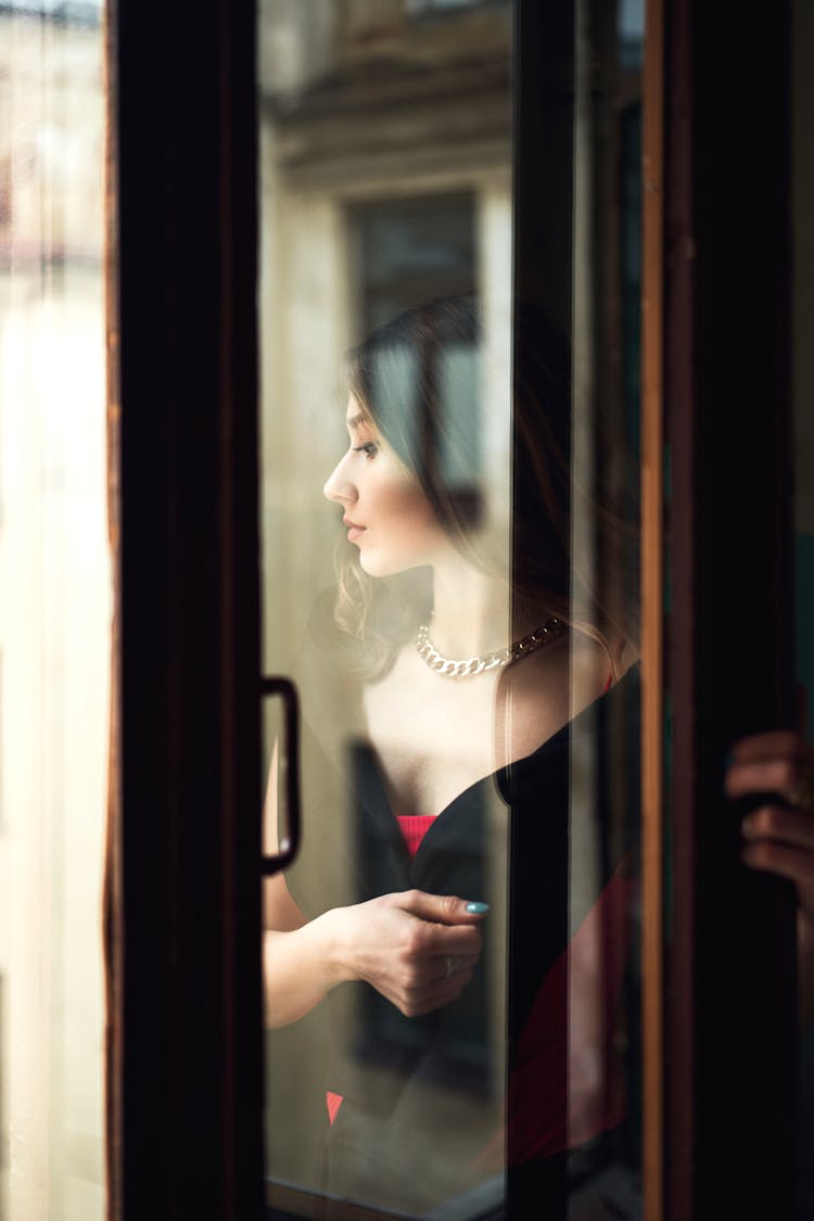 Window Reflection Of Woman Dressed Elegantly