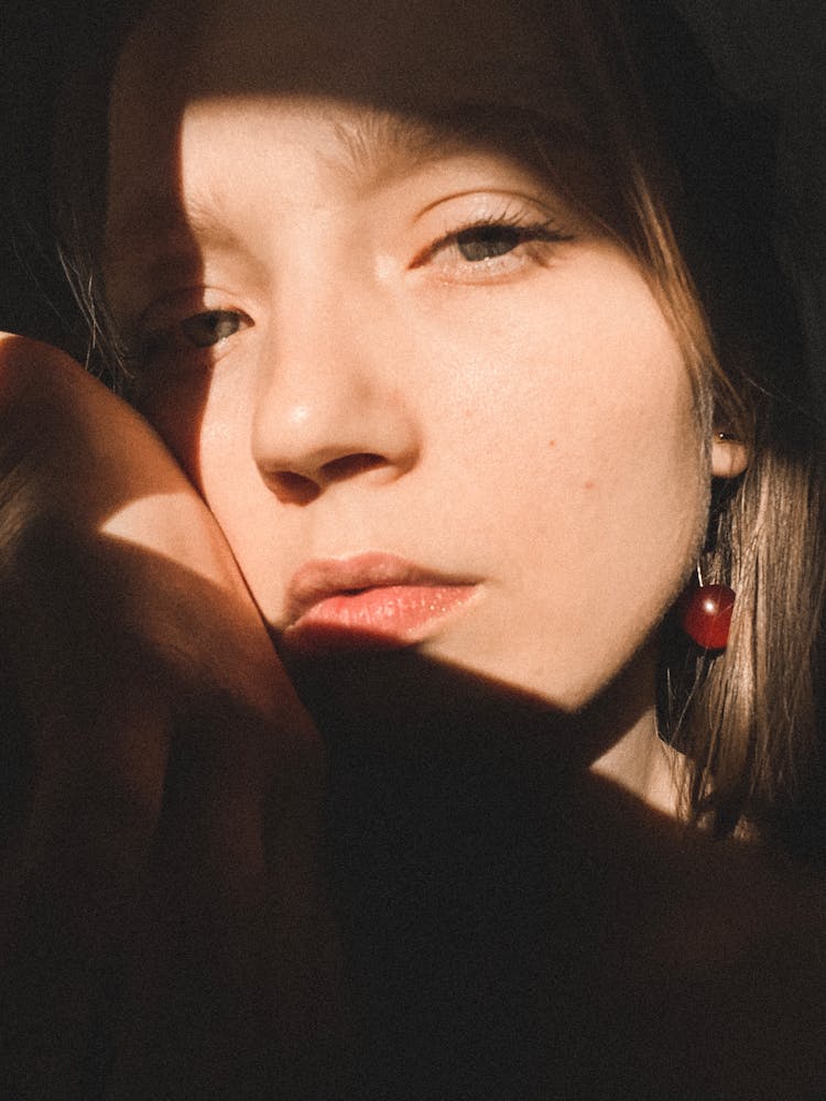 Portrait Of Woman With Sunlight Reflecting On Her Face