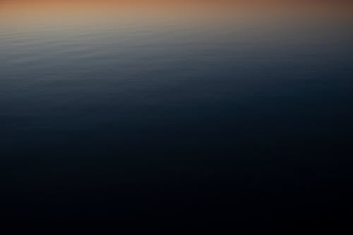 Free Sunset over calm sea background Stock Photo
