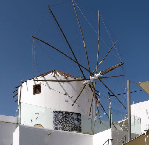 Free A classic windmill under a clear blue sky in Santorini, Greece. Stock Photo