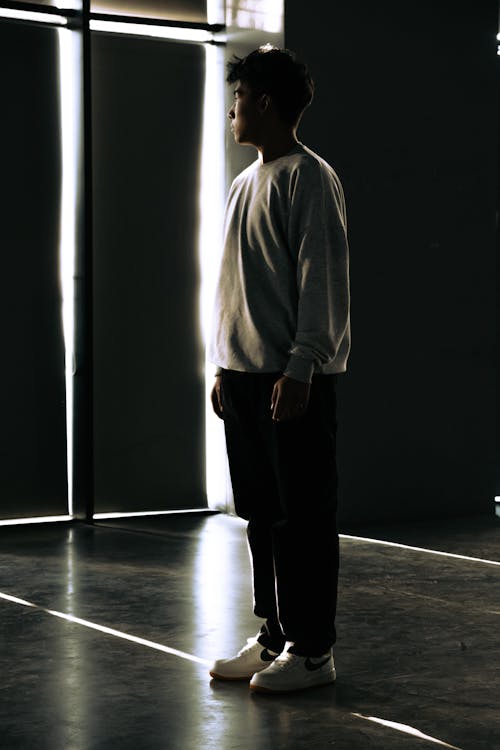 Young Man Standing Still in a Studio 