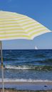 Yellow beach umbrella. Day at the beach.