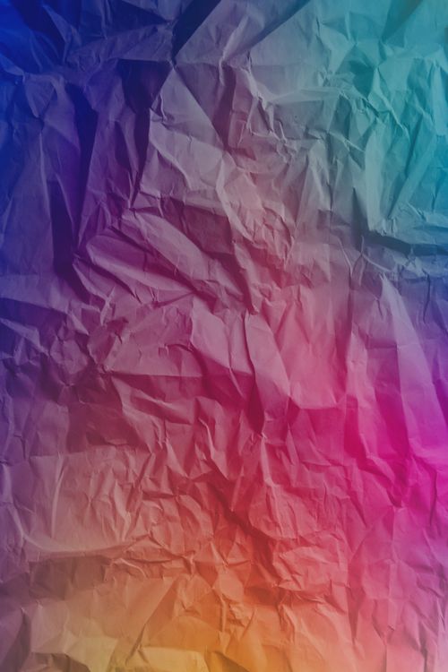 Free Vibrant abstract crumpled paper texture with gradient colors, perfect for creative designs and backdrops. Stock Photo