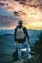 Backview of a Backpacker standing on a Cliff