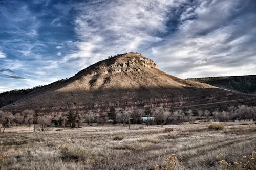 Brown Mountain Under Blue Cloudy Sky