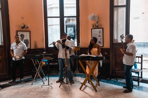 Free A group of musicians practicing their craft inside a cozy room. Stock Photo