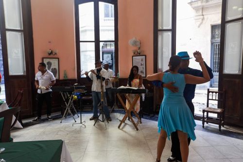 Free A vibrant scene of dancers and musicians performing indoors with Latin flair. Stock Photo