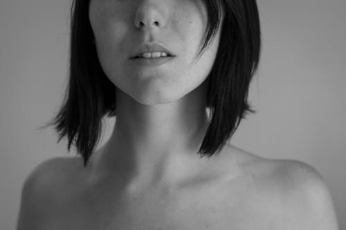 Grayscale Photo of Woman's Shoulders