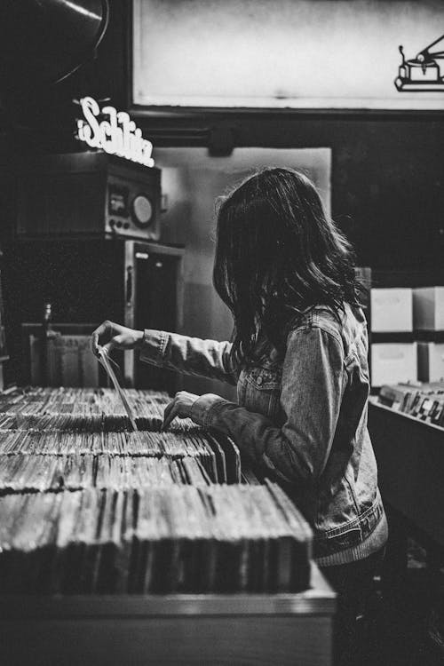 Woman Looking Through Records in a Record Store 