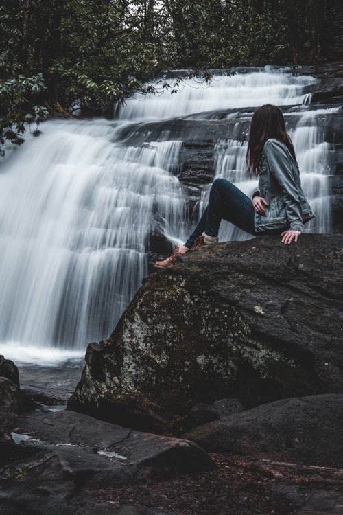 A Woman Standing by a Waterfall · Free Stock Photo