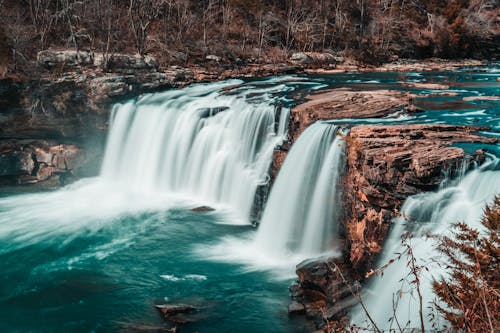 Free A Cascading Waterfalls Through a Rocky Cliff Stock Photo