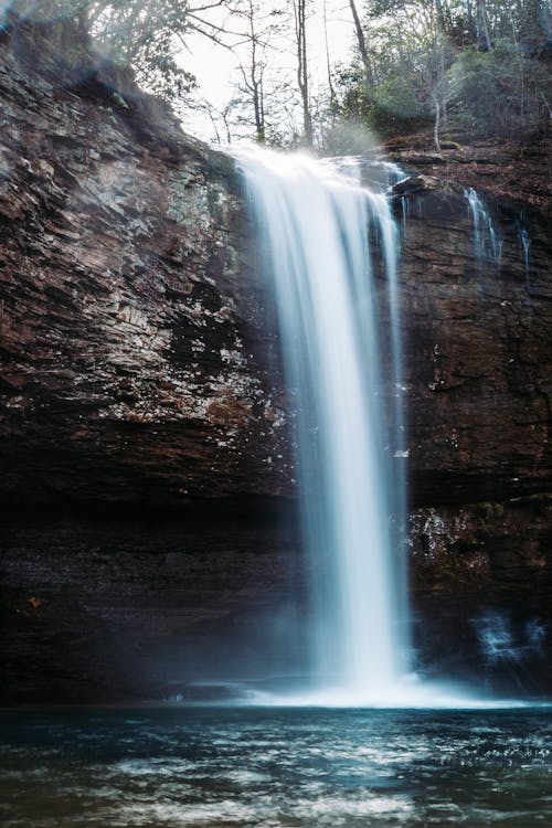 A Cascading Waterfalls from a Rocky Cliff
