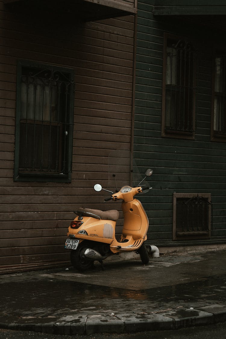 Yellow Scooter On Sidewalk