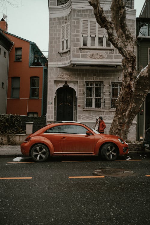 Car on the Side of the Street in City and Buildings 