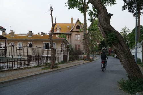 Person Riding a Bicycle on a Town Street