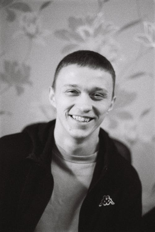 Grayscale Photo of a Man Smiling