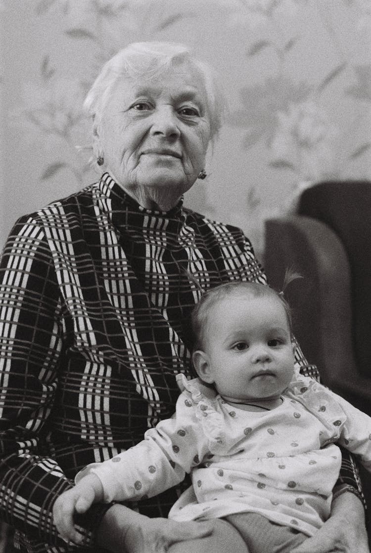 Grandma Holding Baby On Her Lap