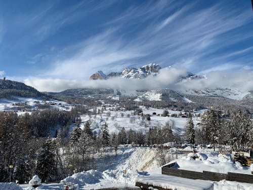 Aerial Photography of Cloudy Mountains Covered by Snow during Winter