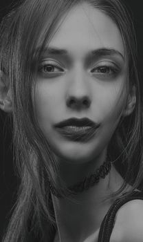 Elegant black and white portrait of a young woman with an artistic touch.