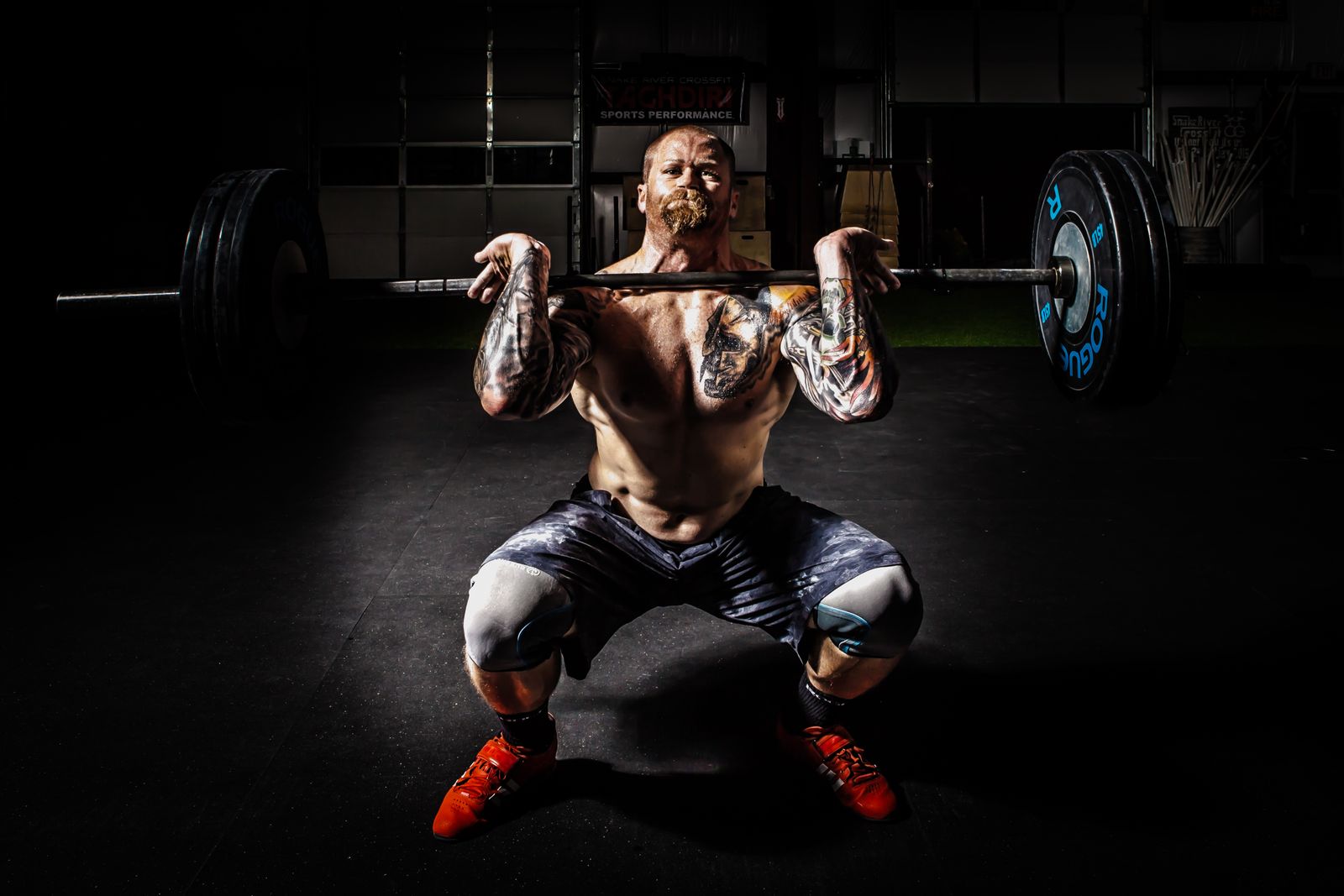 Person lifting weights to add progressive resistance alongside cardio dance workouts