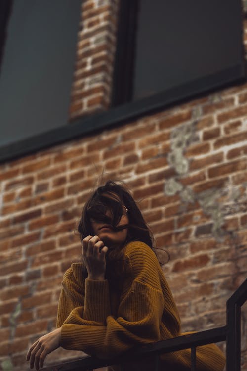 Low Angle Shot of Stylish Woman in Yellow Sweater 