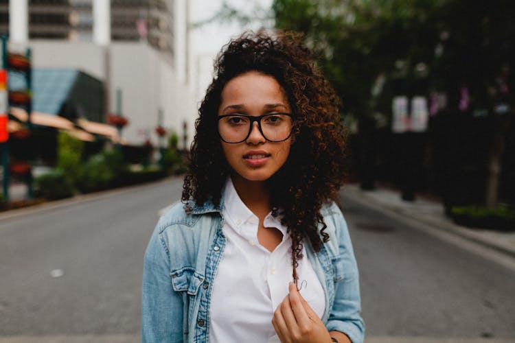 Nice Woman With Curly Dark Hair Standing On Road