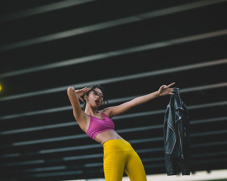 Young Woman With Open Mouth Stretching Arm Forward