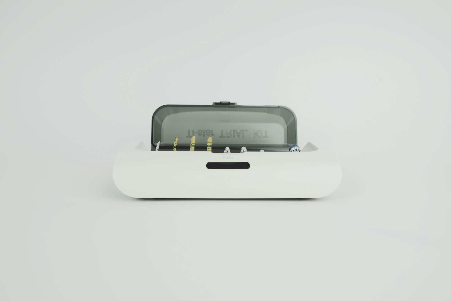 A sleek and modern dental instrument kit displayed on a minimal white surface, ideal for medical themes.