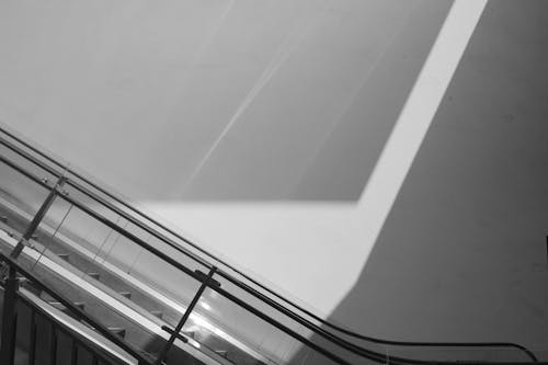 Black and White Photo of Escalators