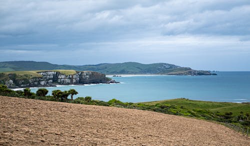 Clouds over Sea Shore with Cliff