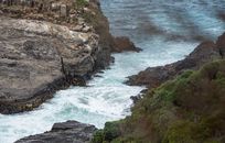 Waves crashing on Boulders