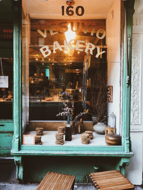 Charming vintage bakery storefront with cookies in a window display.