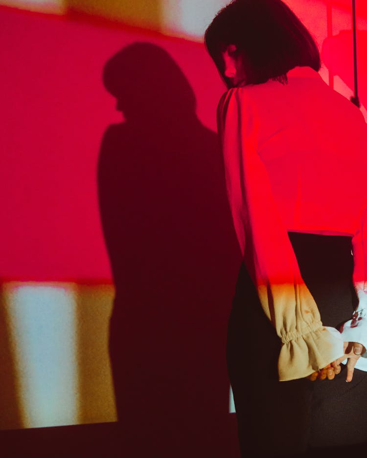 Woman Posing In Studio In Red Lighting 