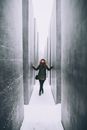 Woman in Black Jacket and Black Pants Standing on White Floor