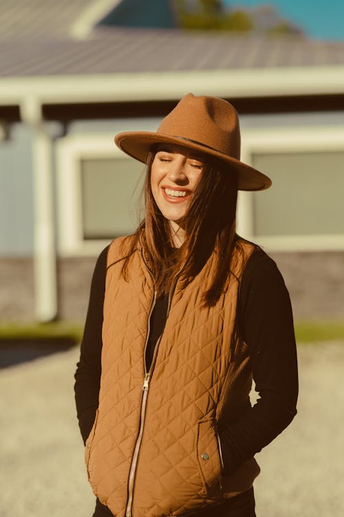 Free Smiling Woman in Brown Vest and Brown Cowboy Hat  Stock Photo