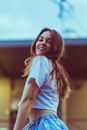 Young Smiling Woman with Long Brown Hair Posing Outdoors
