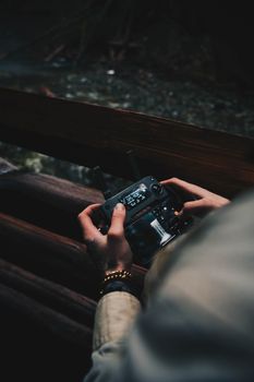 An intriguing shot of hands holding a drone controller with a focus on technology and adventure.