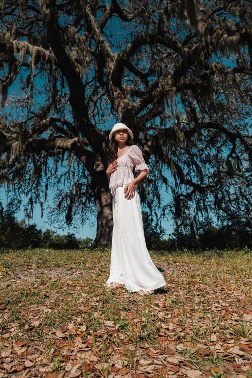 Woman in White Long Dress Standing on an Old Tree · Free Stock Photo